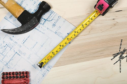 Blueprint and tools on wood - Building a new construction home in Florida