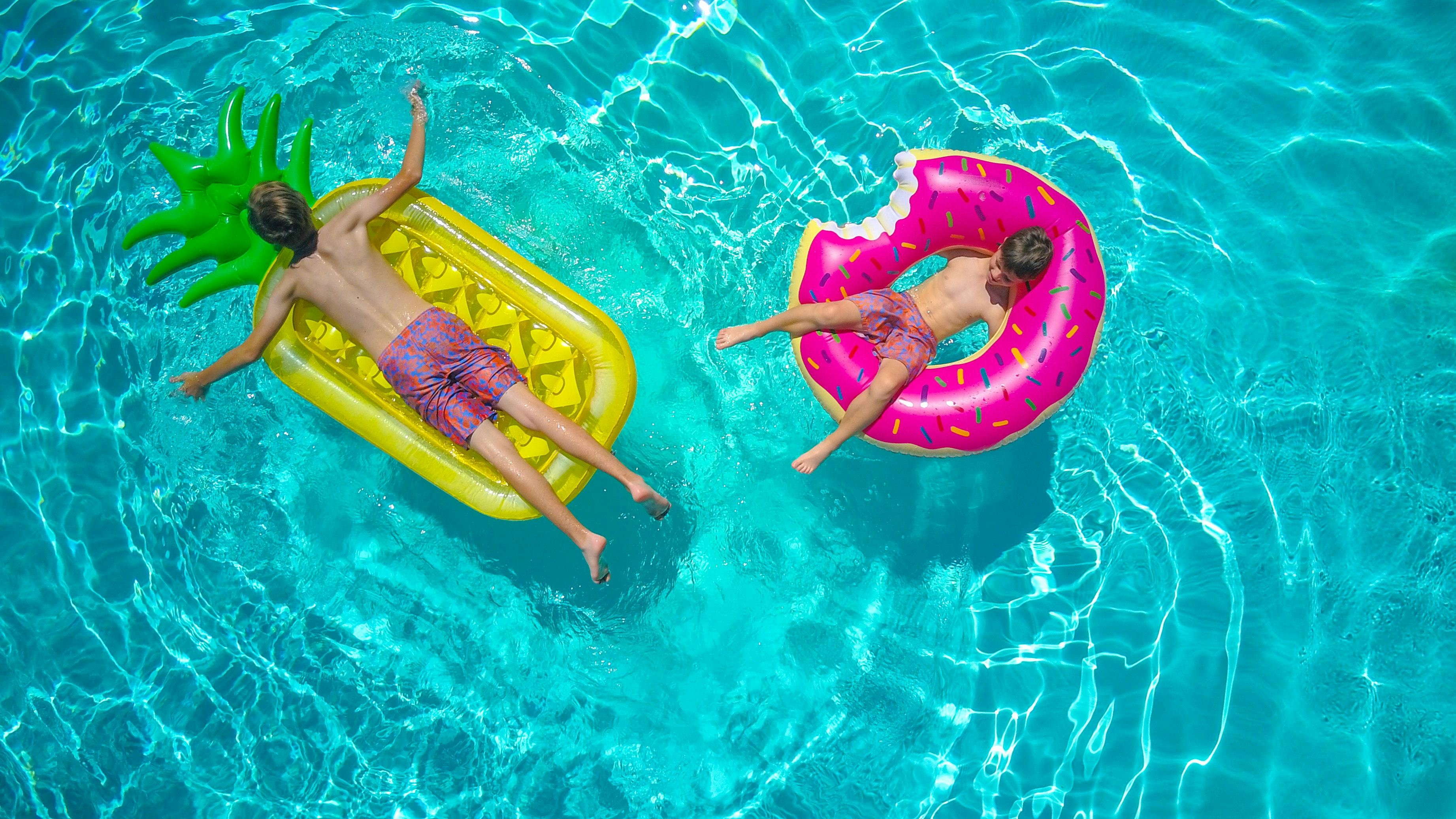 People in a pool on floats