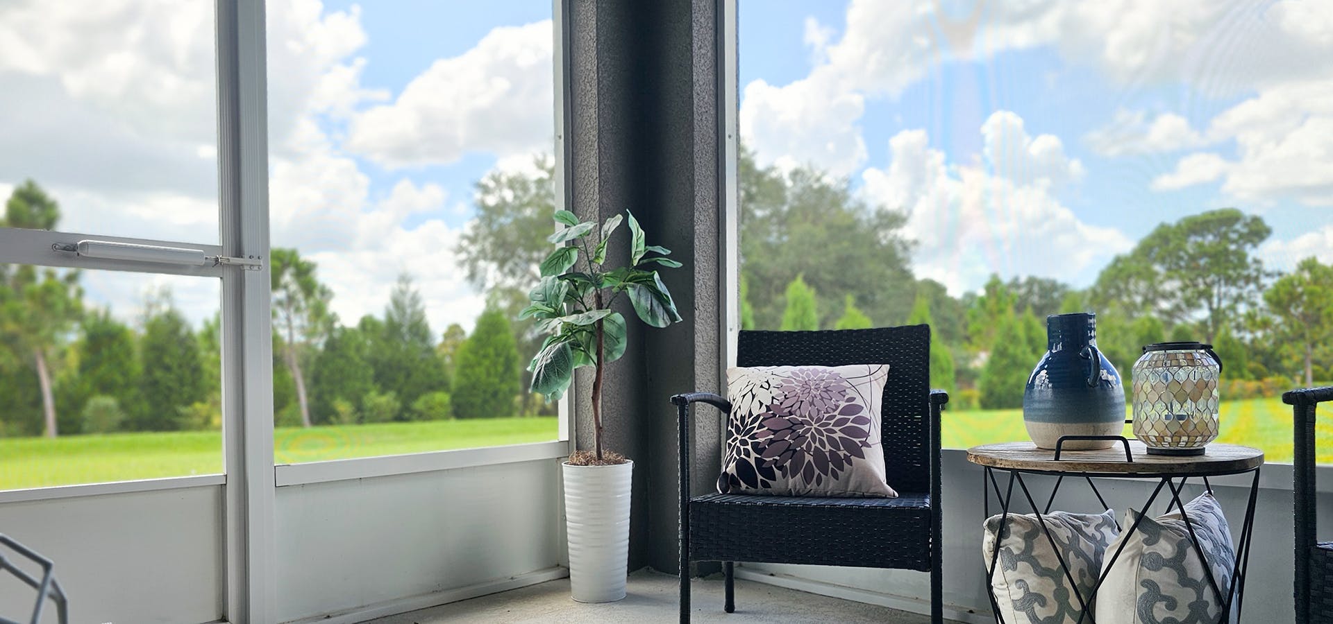 Green trees and blue skies views from a screened lanai in Parrish, FL