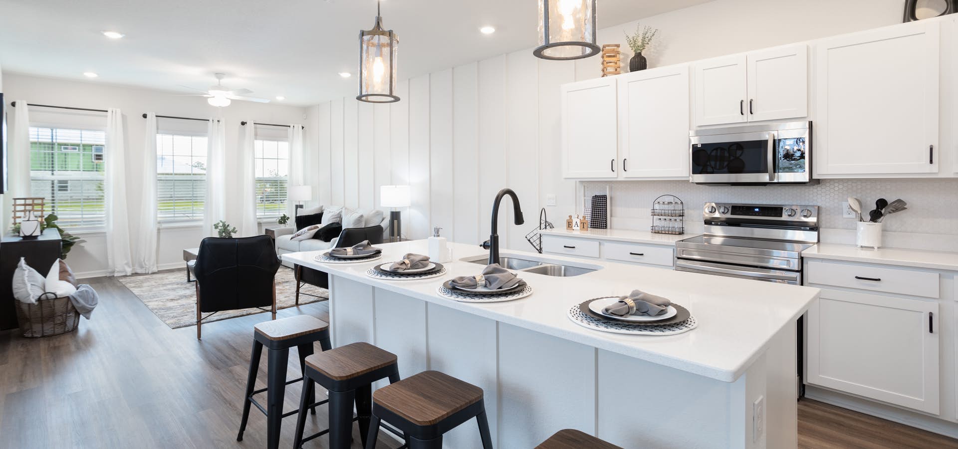 Modern farmhouse style kitchen decor with white cabinets and contrasting dark metal hardware