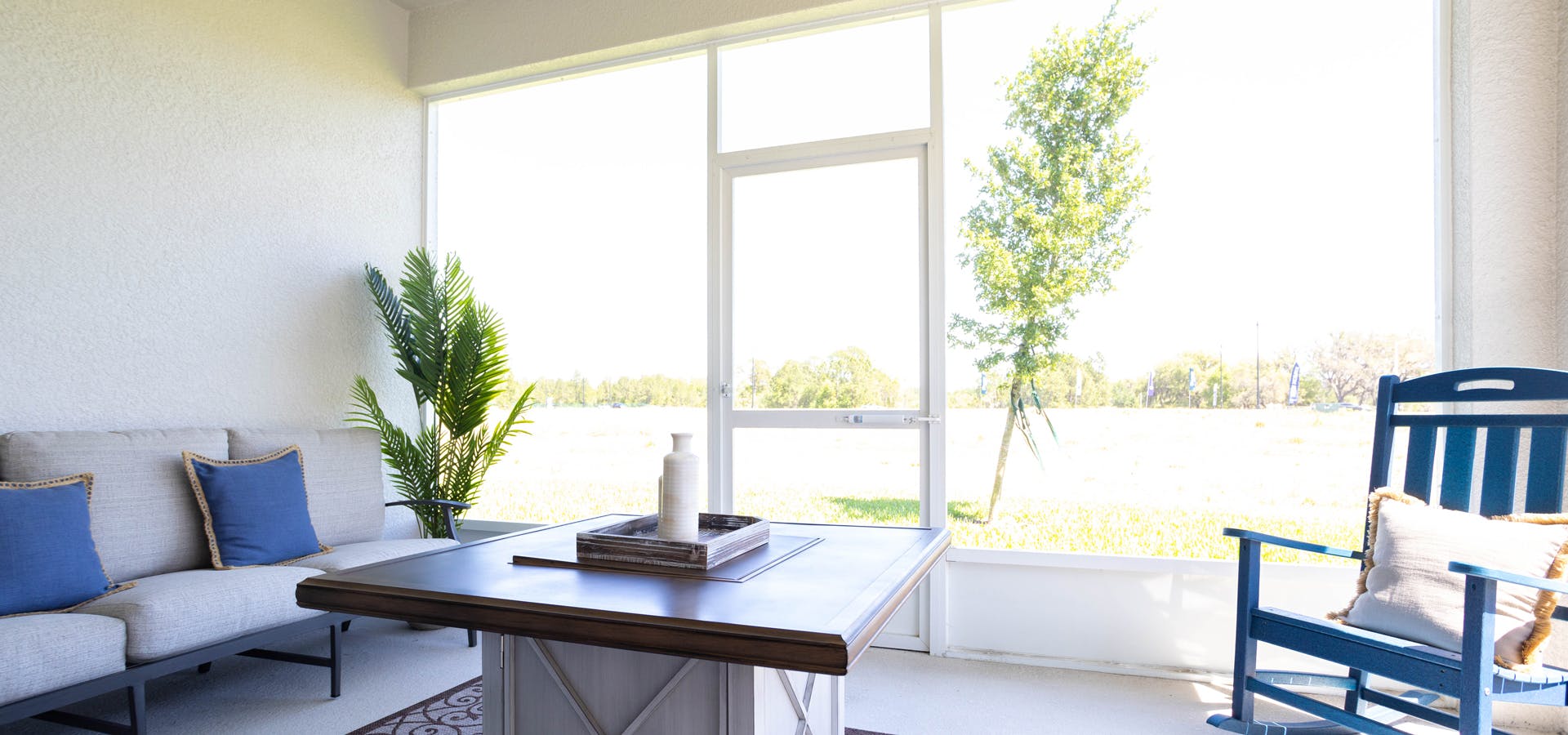 Covered lanai looking out at open space adjacent to a Belleview new home