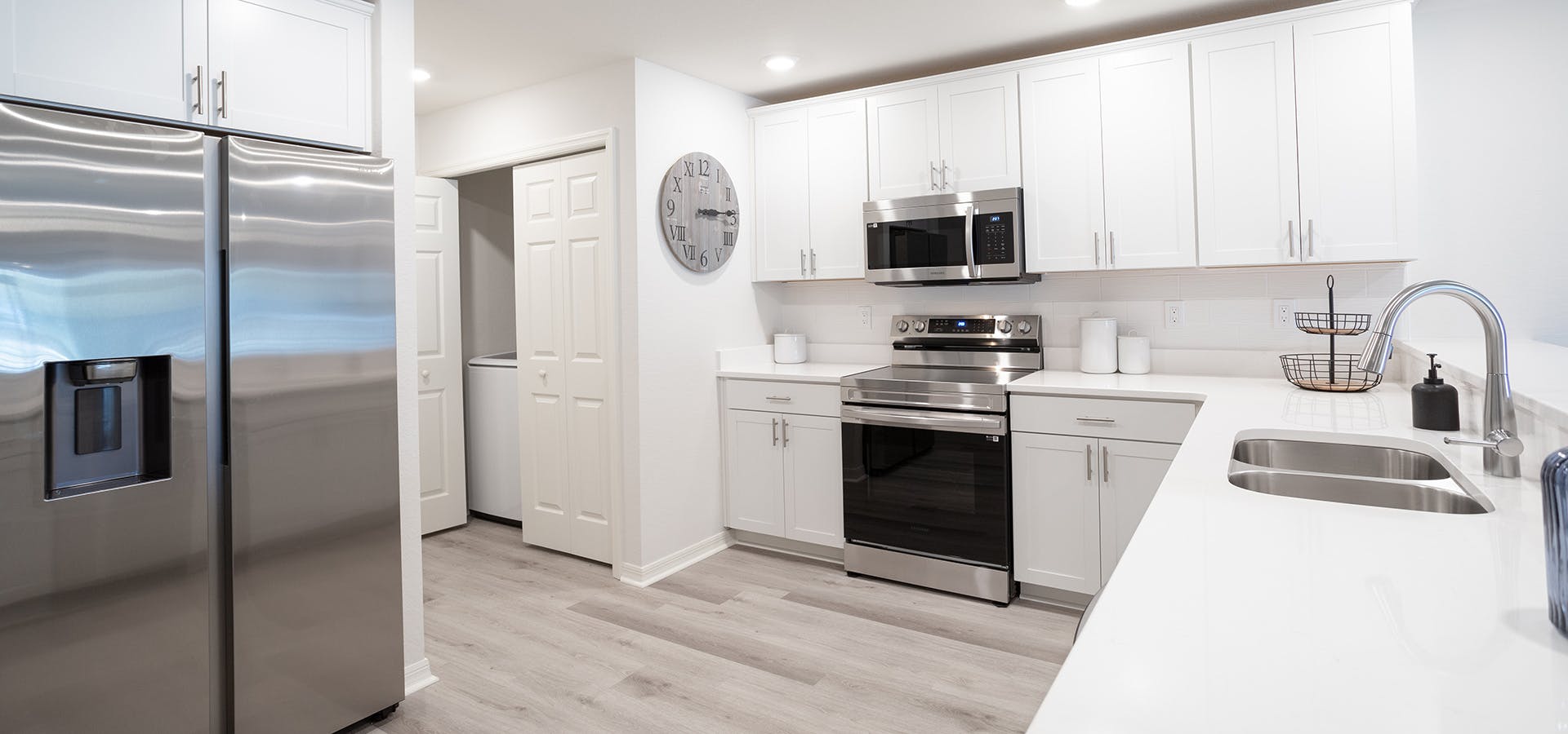 Kitchen with quartz counters, 36-inch cabients, and Samsung appliances in the Azalea townhome by Highland Homes
