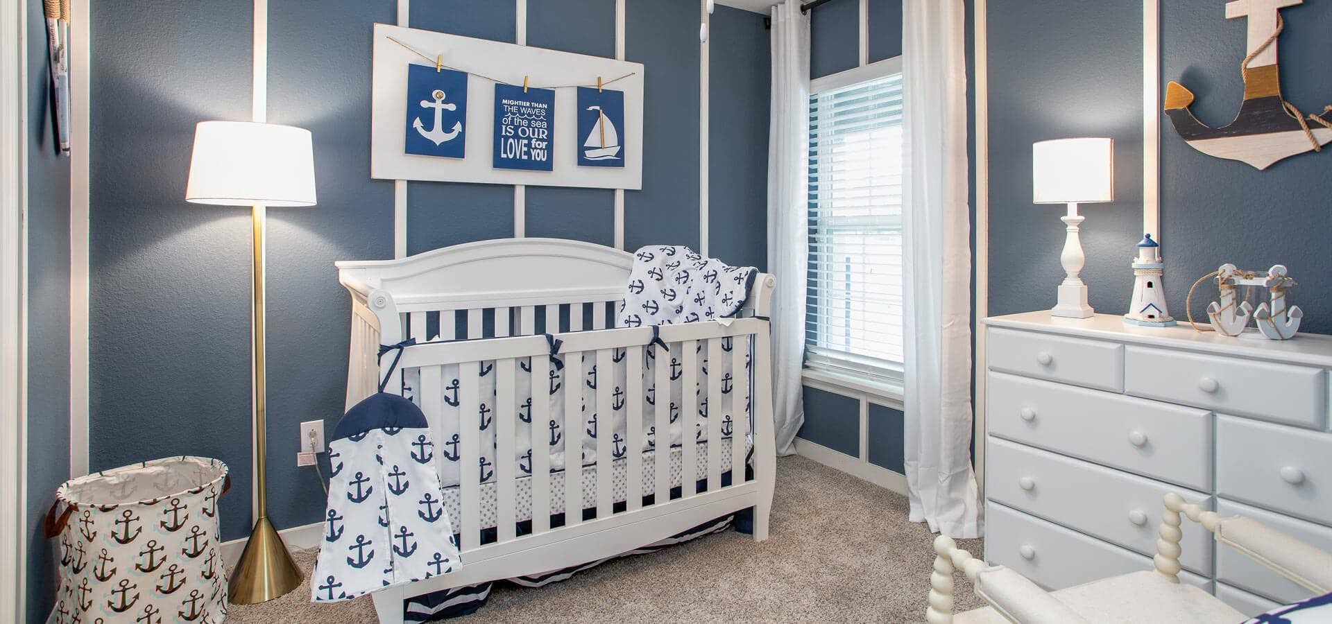 A nursery decorated in blue and white nautical theme