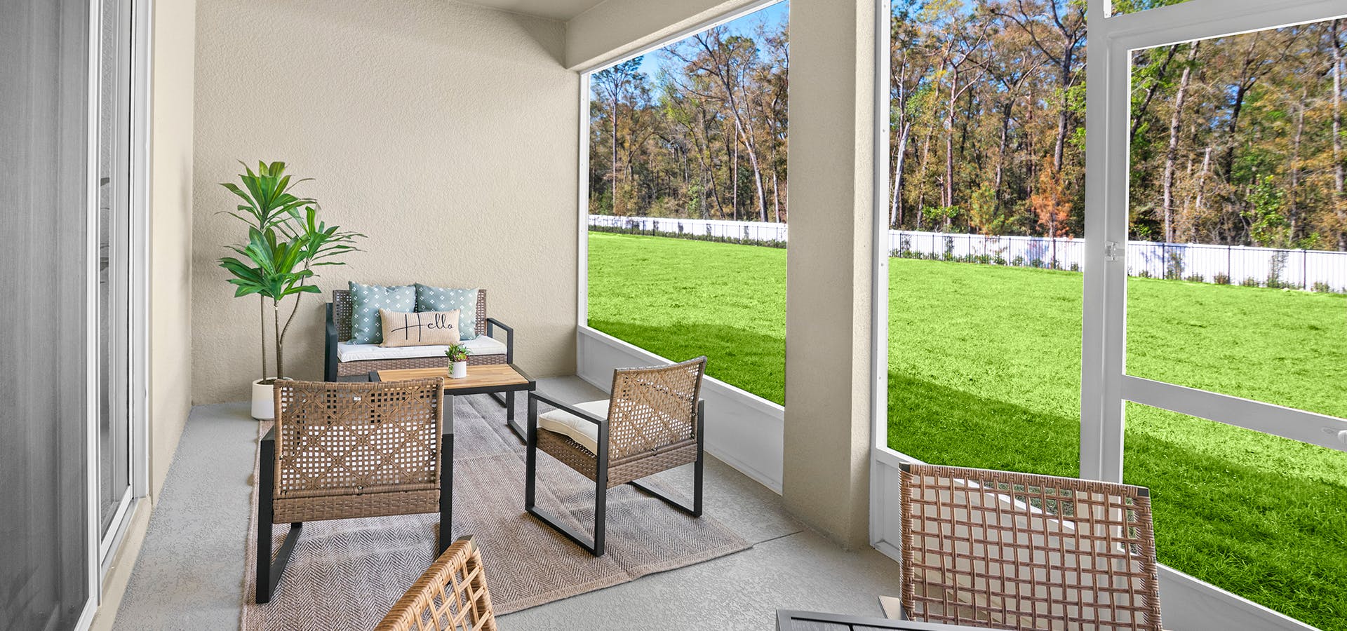 A screened lanai overlooks a green lawn and trees at Copperleaf in Ocala