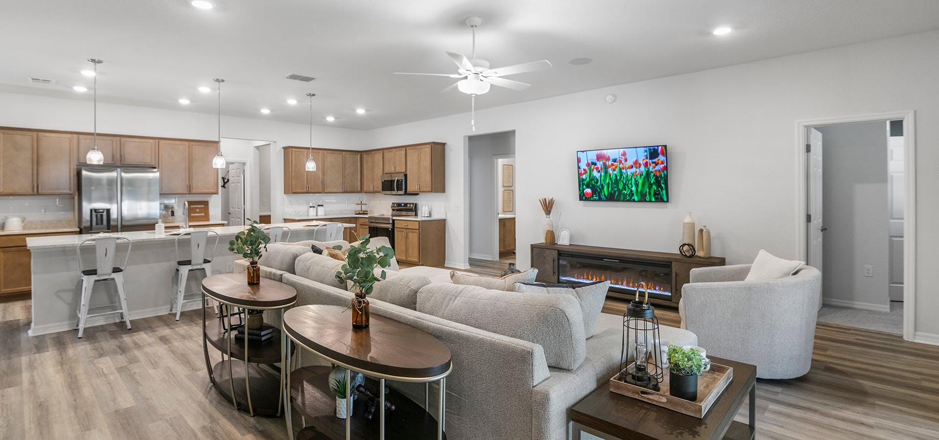 Open living area with wood finishes in Highland Homes' model home at Copperleaf in Ocala