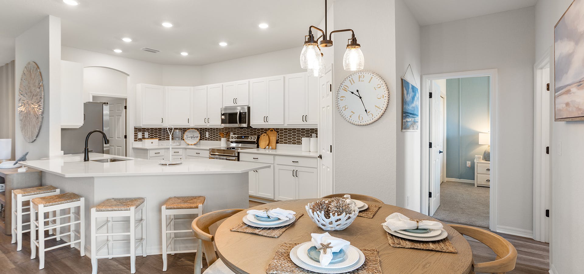 Kitchen with white cabinets and dark metal accents