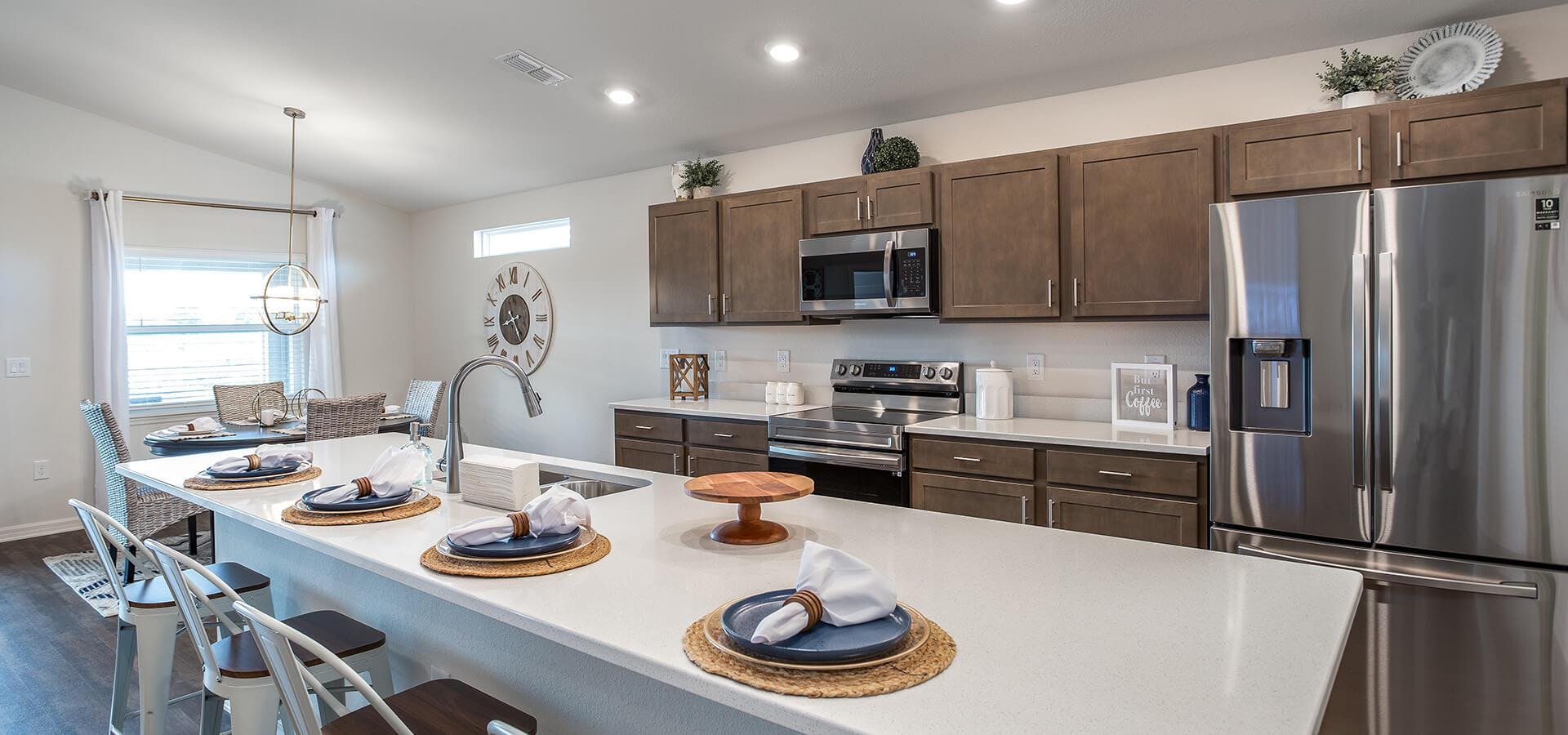 Open kitchen with wood cabinets and quartz countertops