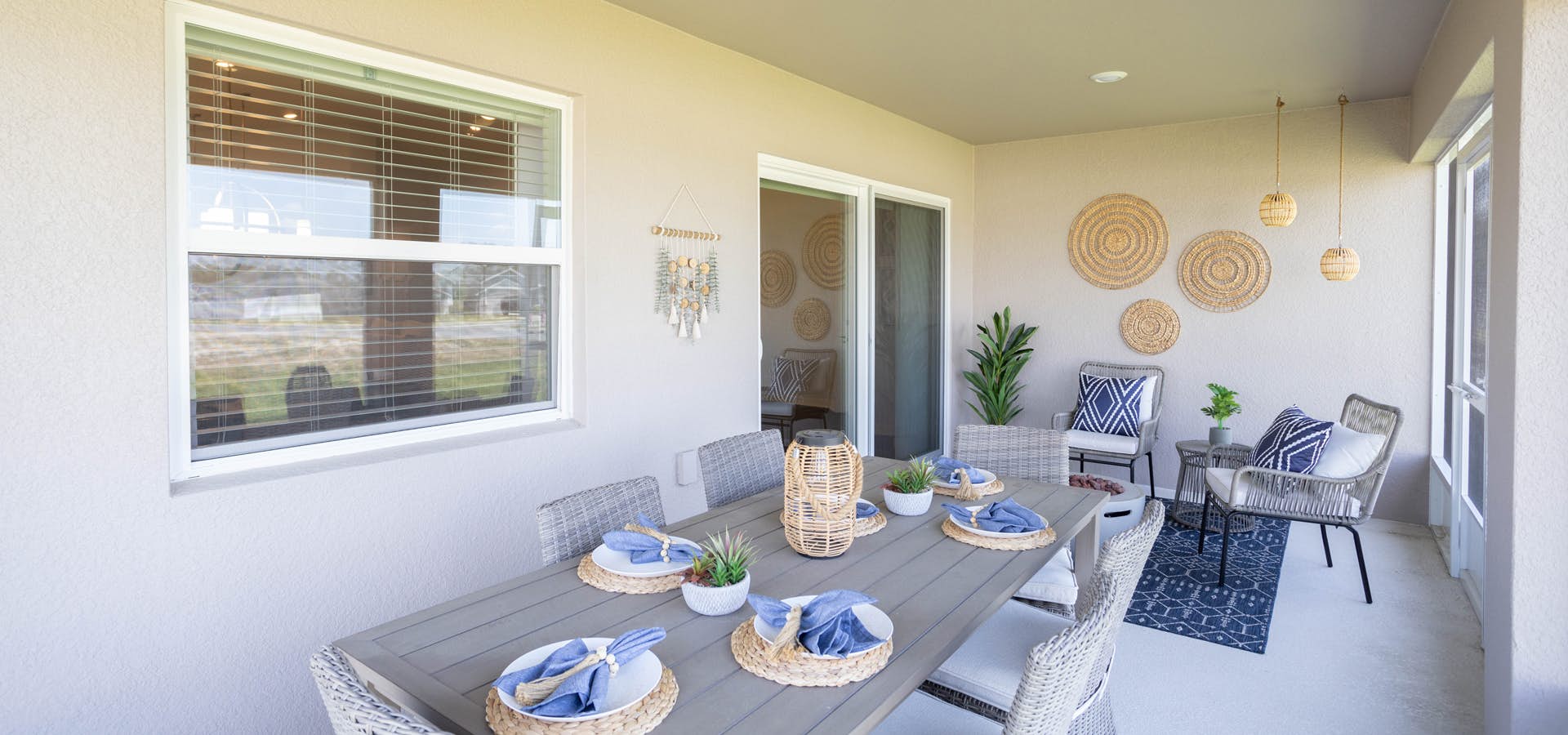 Spacious covered lanai area with large table and lounge chairs