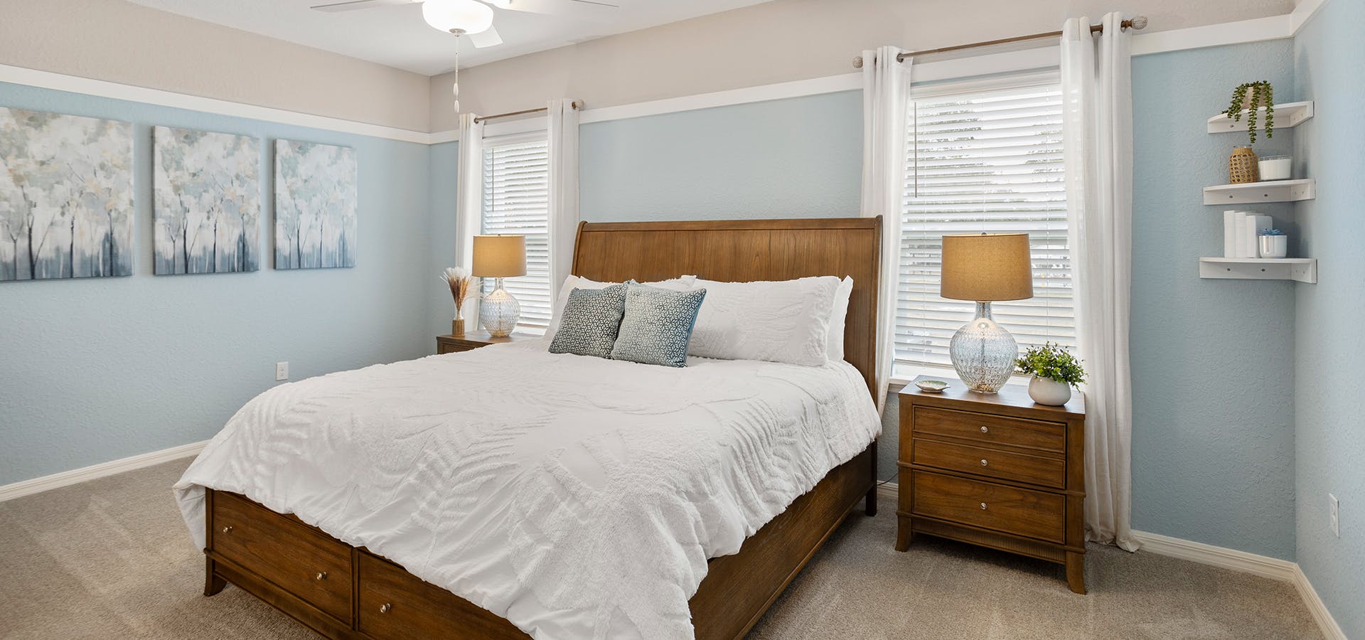 Calming blue, wood, and white decor in the owner's suite of this new model home in Ocala