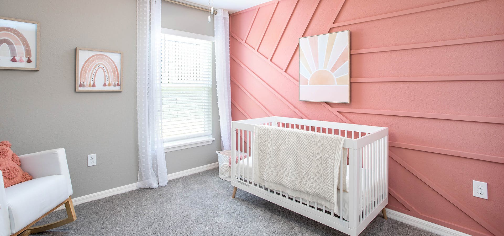 Nursery with a pink accent wall