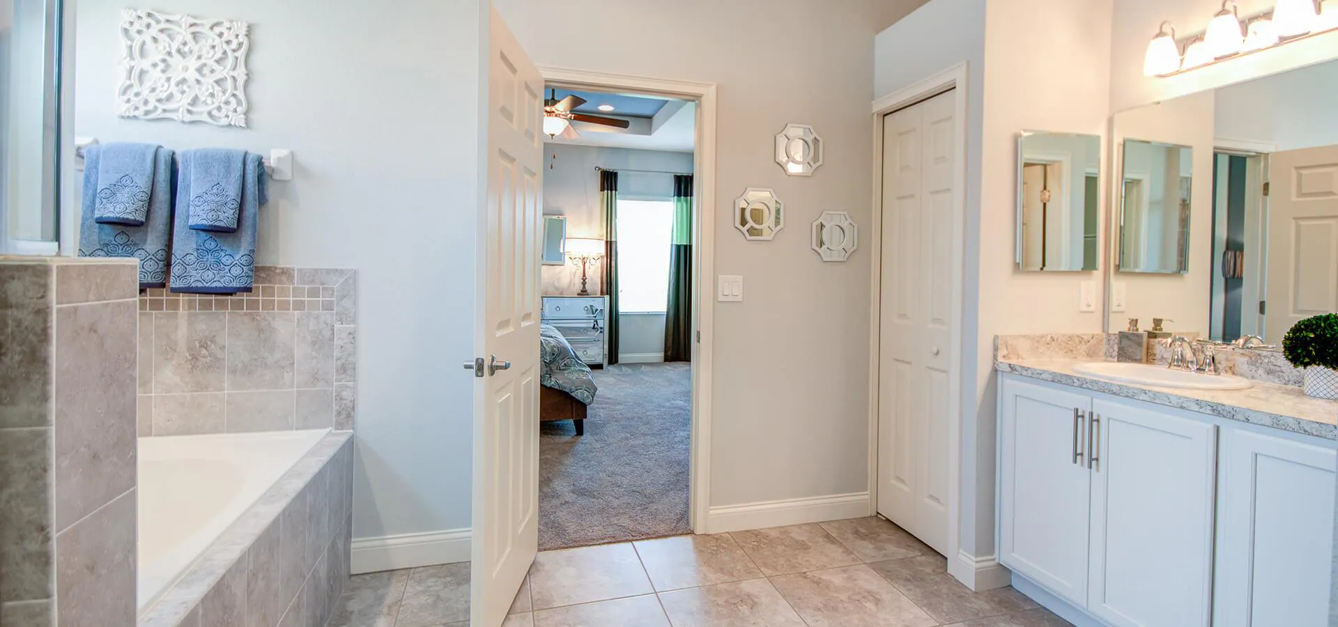 En-suite bathroom with linen closet and large tub