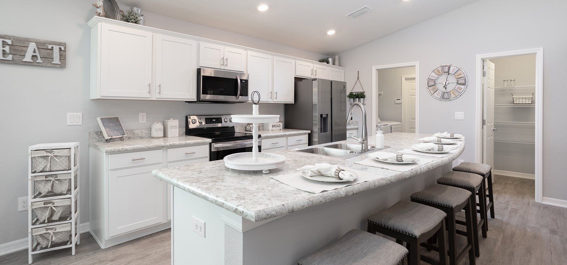 Island kitchen with neutral and white colors in Highland Homes' Raychel home plan