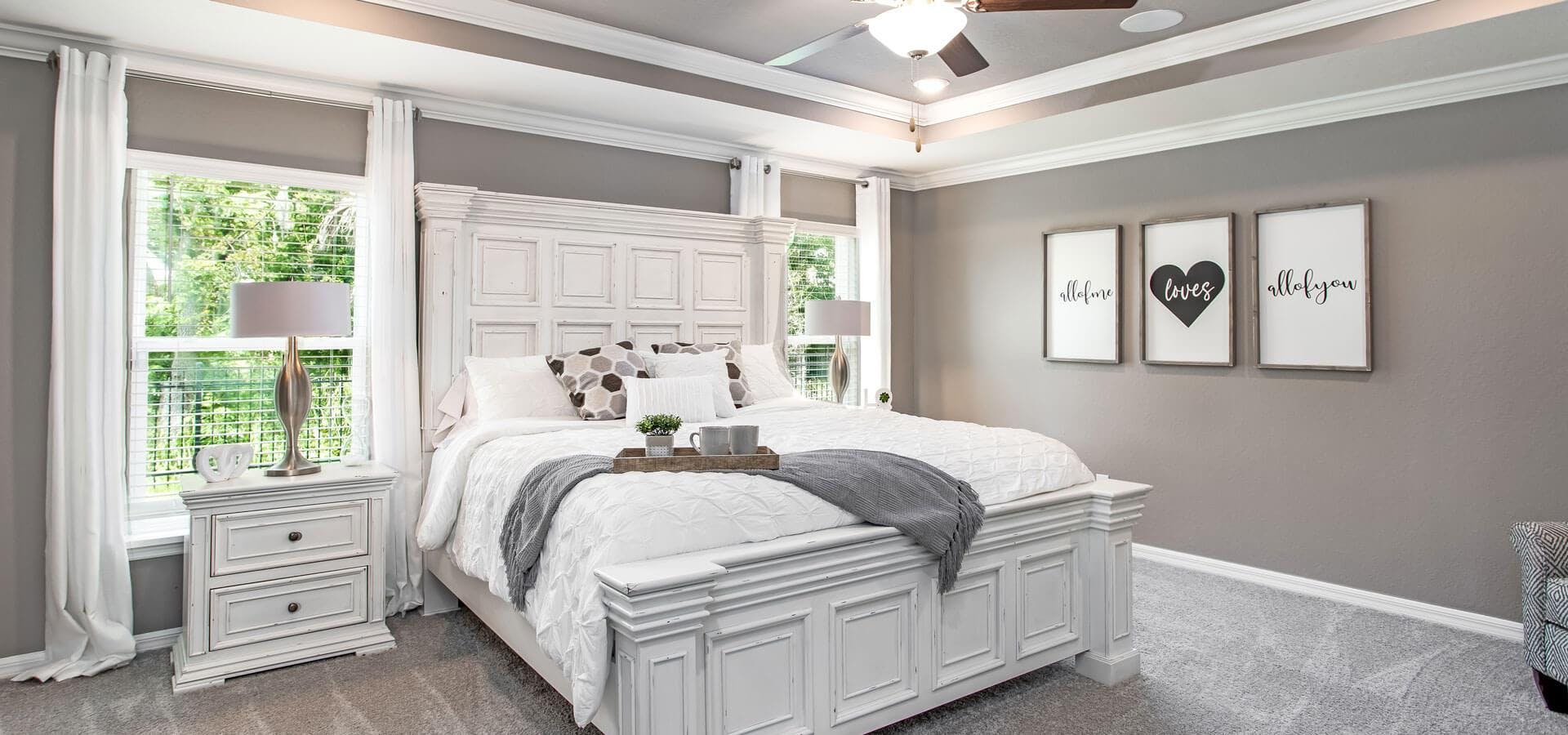 Large owner's suite with eloquent tray ceiling in the Raychel, a new home plan by Highland Homes