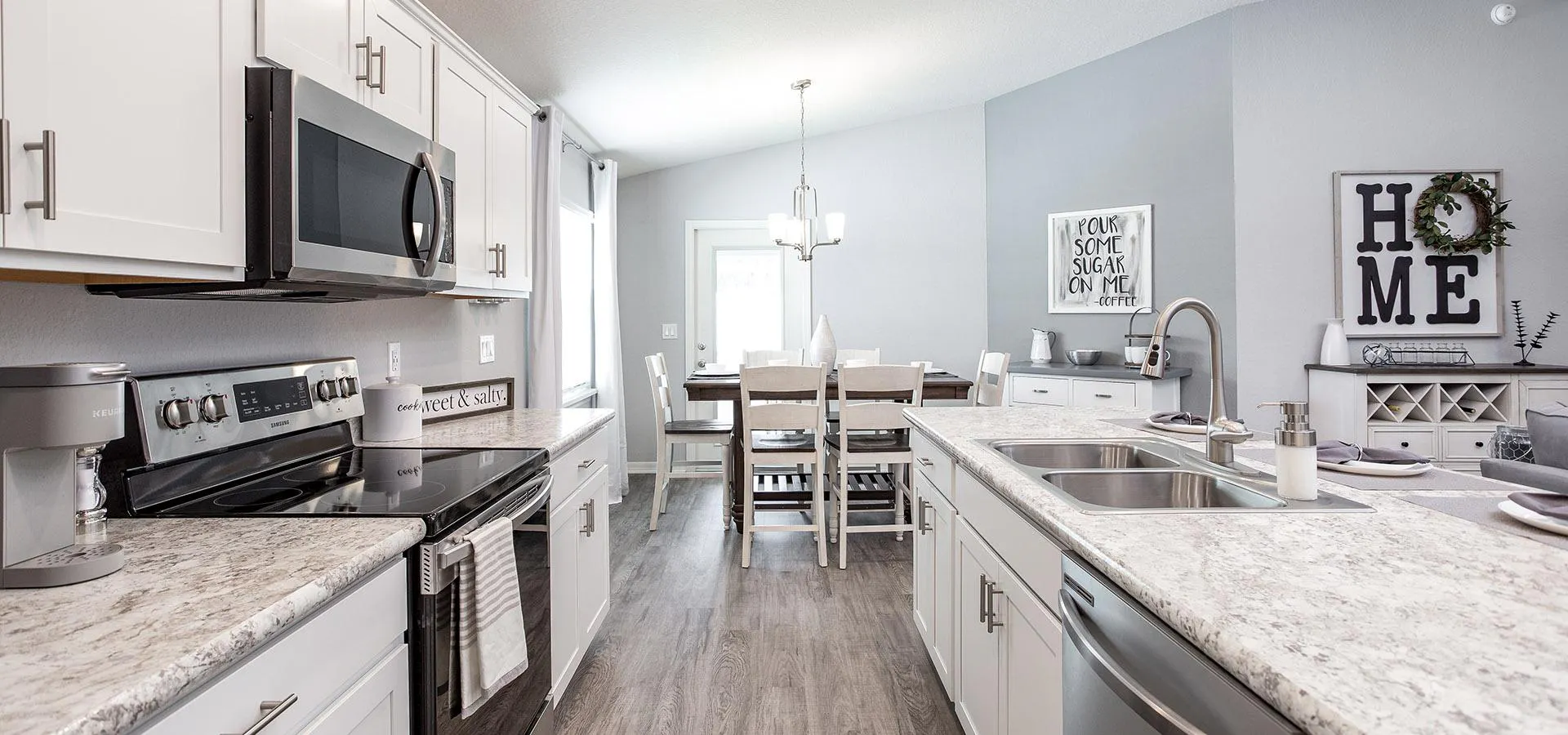 Gourmet kitchen with sunny dining cafe from Highland Homes