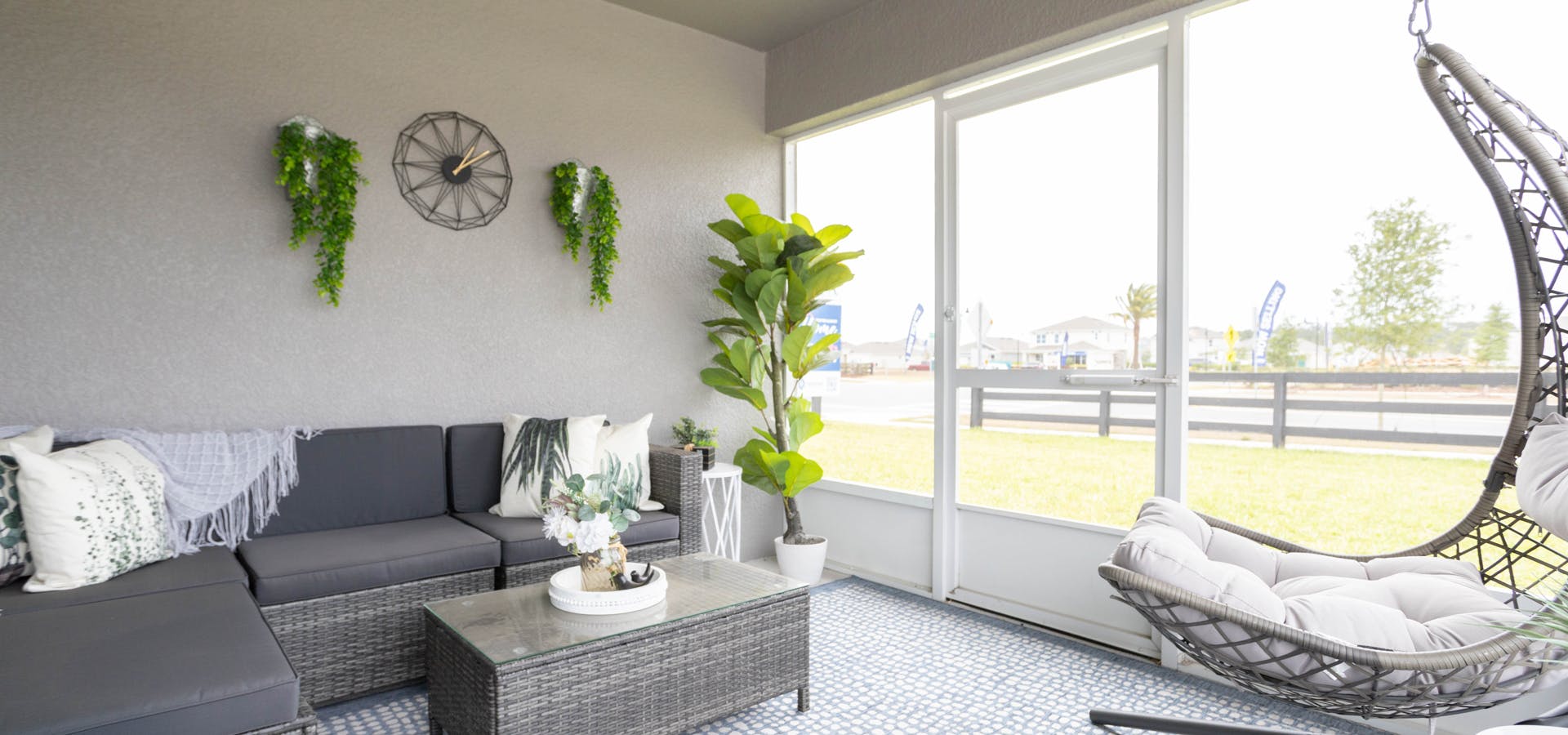 Covered lanai with sectional patio furniture and hanging chair with optional screening - Raychel home plan by Highland Homes