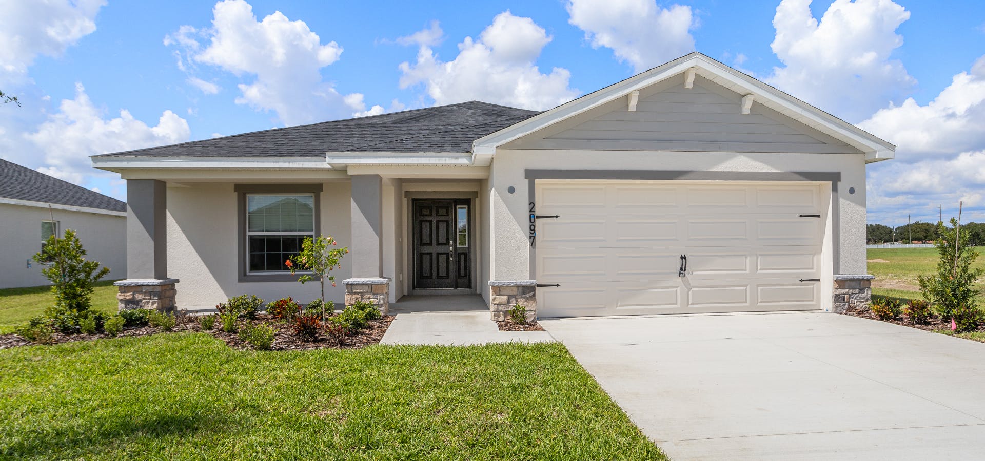 The Raychel by Highland Homes includes Craftsman style siding and stone exterior details