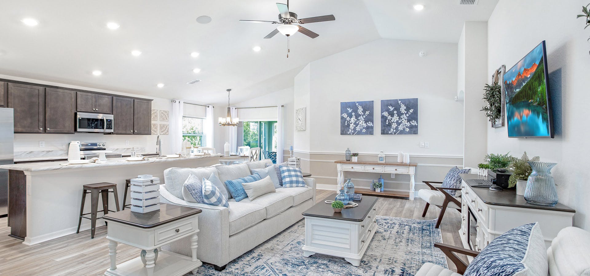 Bright and open living area with volume ceiling and coastal -inspired furnishings