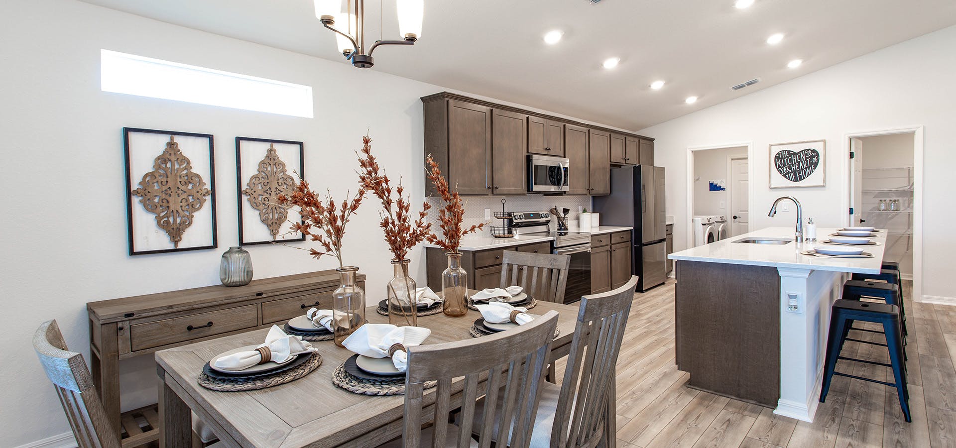 Dining area and kitchen with wood flooring, cabinets, and furniture