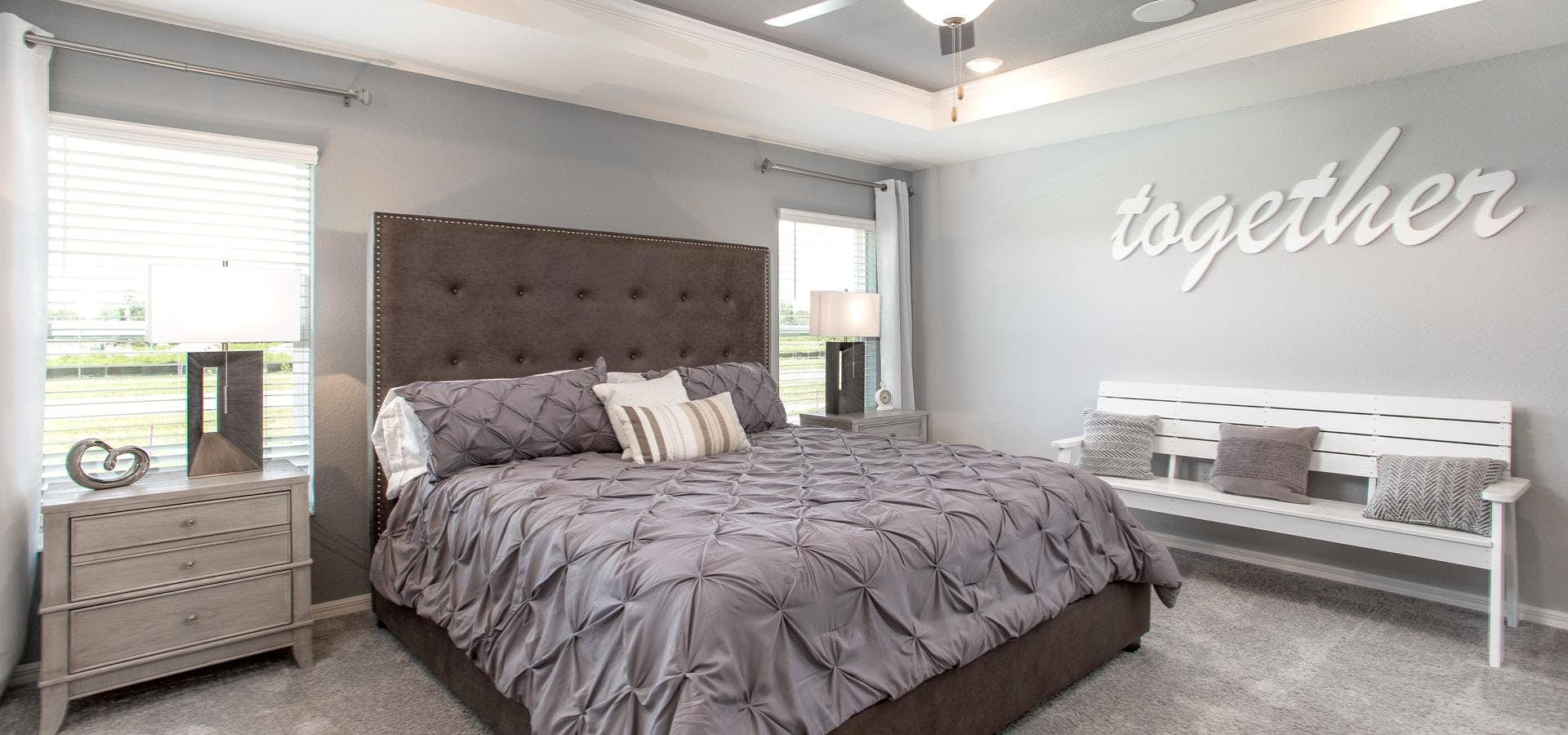 Primary bedroom with elegant tray ceiling in Winter Haven, Florida