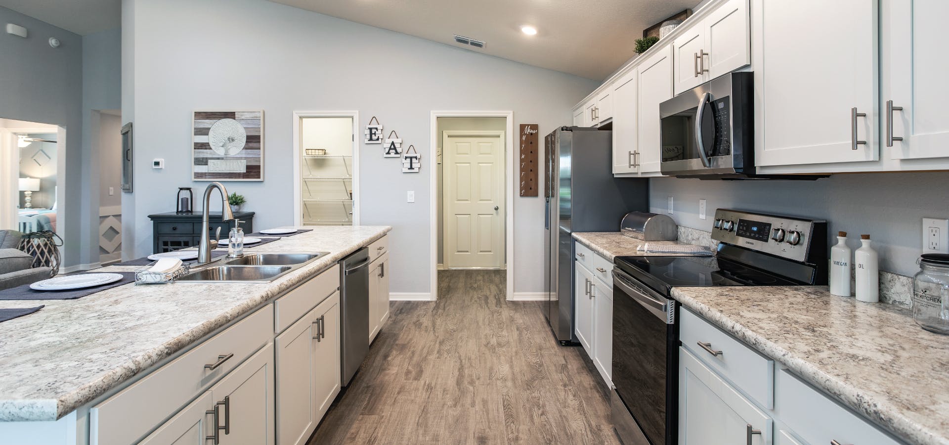 Modern kitchen with large walk-in pantry in VillaMar new home community