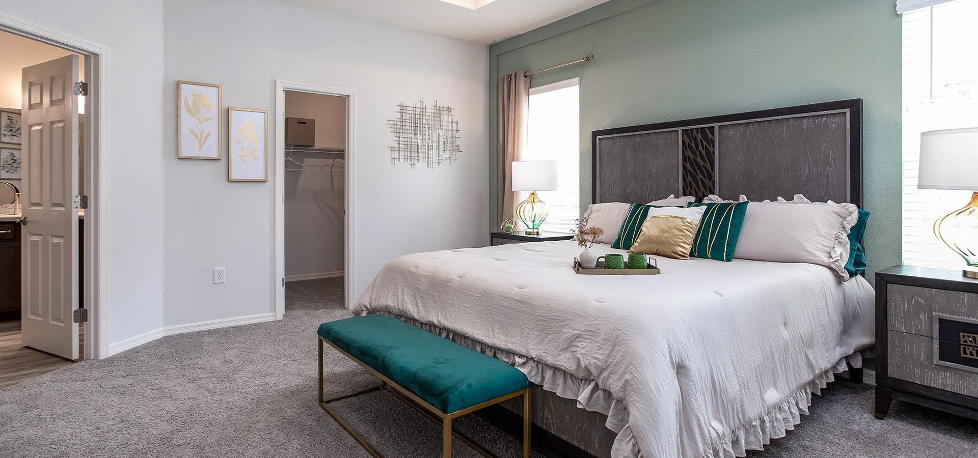 Large master bedroom with soft sage green interior paint