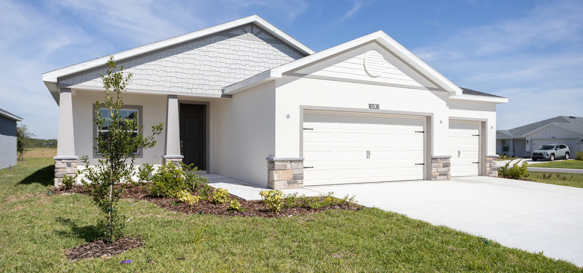 Exterior of a 3-car garage home available at Touchstone in Lakeland