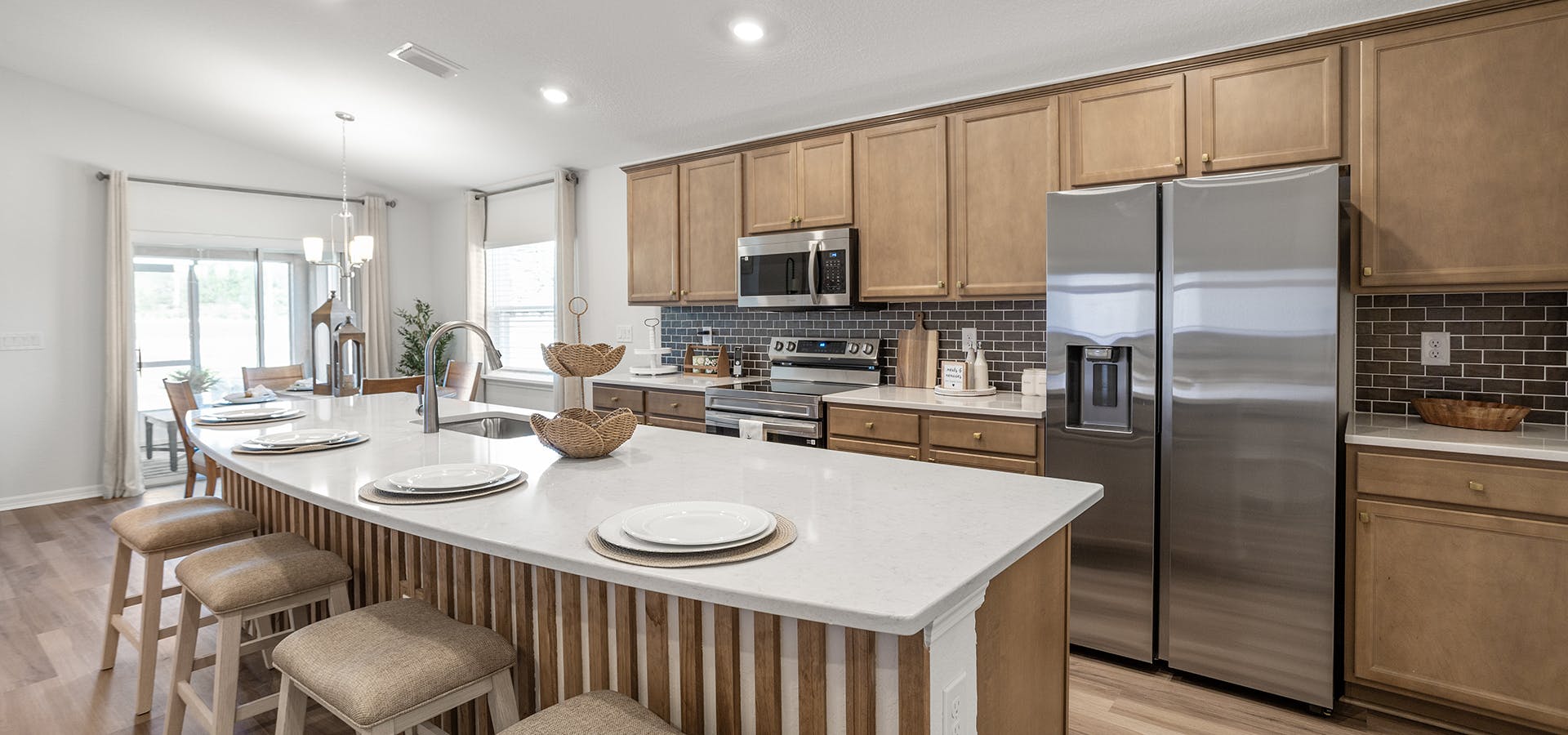 Kitchen with wood cabinets and white quartz in a new construction home in Belleview, FL