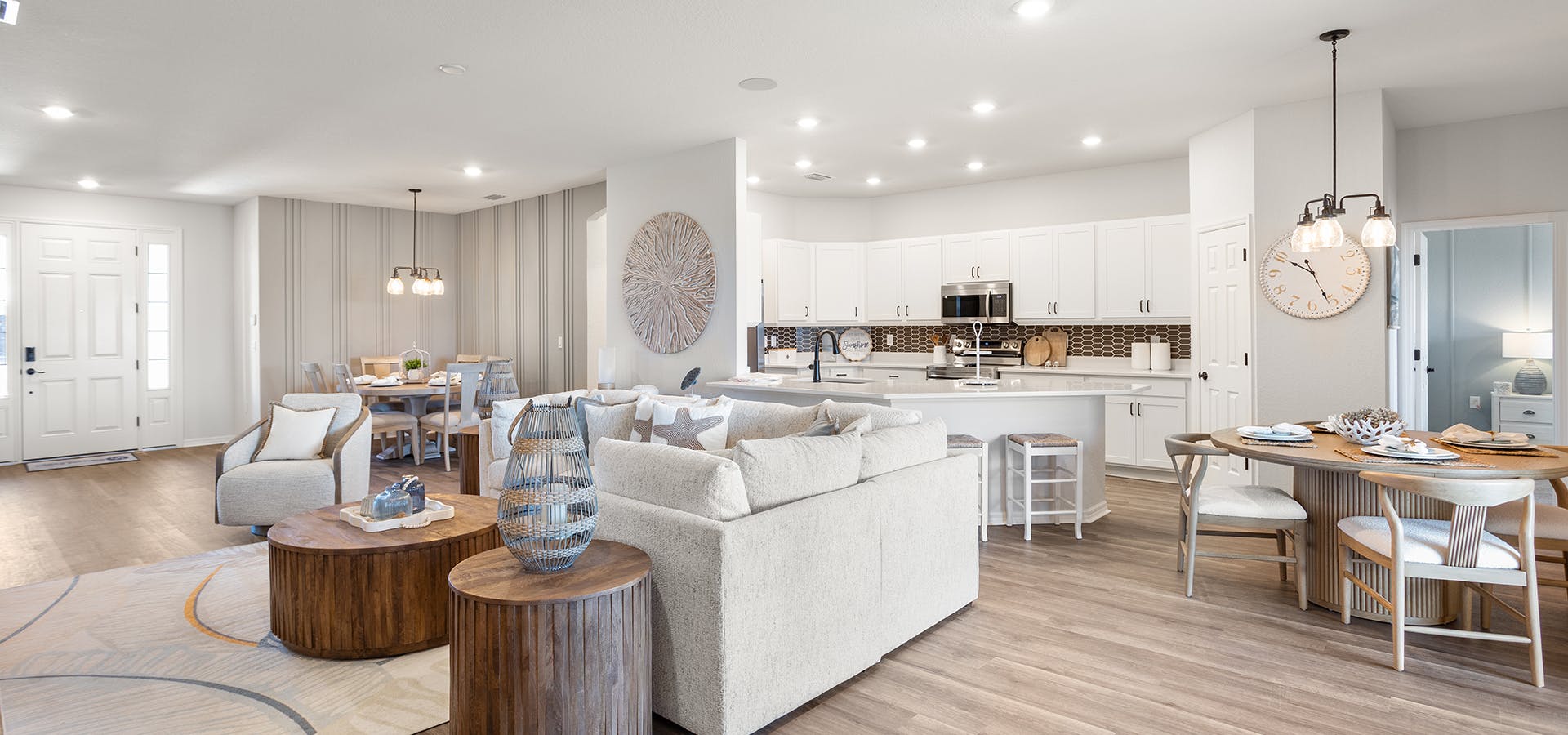 Open living area in the Westin II by Highland Homes in Tampa, decorated with mixed woods and light colors.