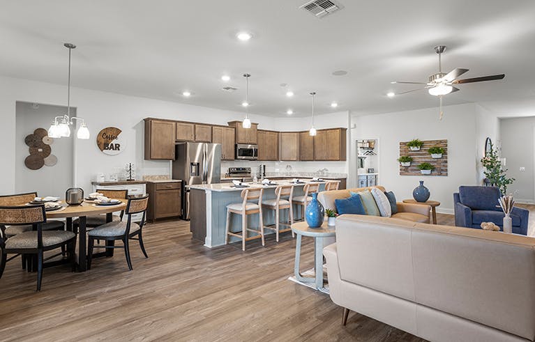 Open-concept living space with a large kitchen and dining area, in a St. Cloud, FL model home.