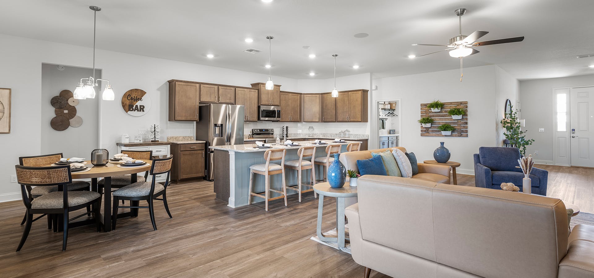 Open-concept living space with a large kitchen and dining area, in a St. Cloud, FL model home.