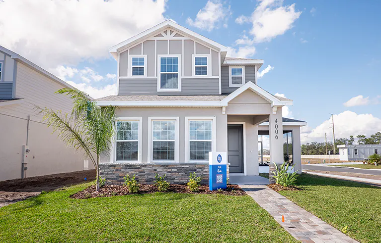 Exterior of the Aria bungalow by Highland Homes, featuring stone, trim, and paint accents.