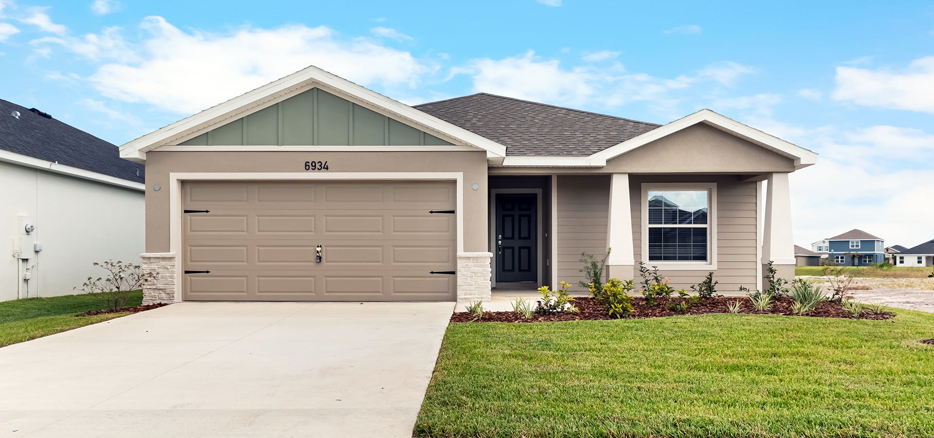 Florida new home with Craftsman-style, exterior, front porch, and 2-car garage