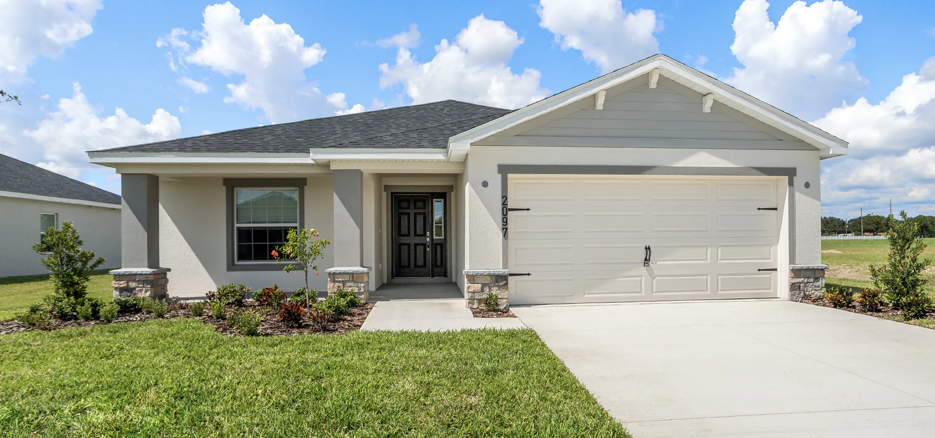 Raychel new home floor plan Crafstman-style exterior with a 2-car garage and front porch