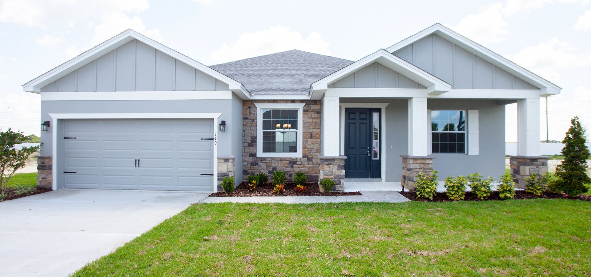 Florida new home with Craftsman-style, exterior, front porch, and 2-car garage