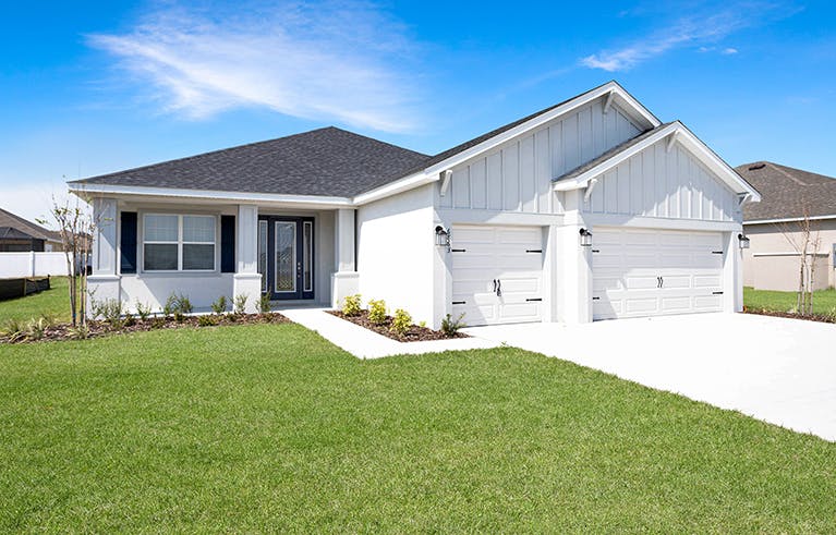 Exterior of a Florida new construction home with a front porch, shutters, and Craftsman style details.