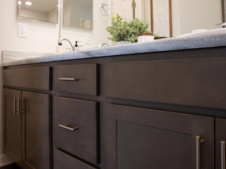 Birch wood bathroom vanity cabinets in a Florida new home by Highland Homes