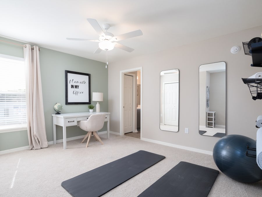 An accent wall adds a pop of color in this home yoga room