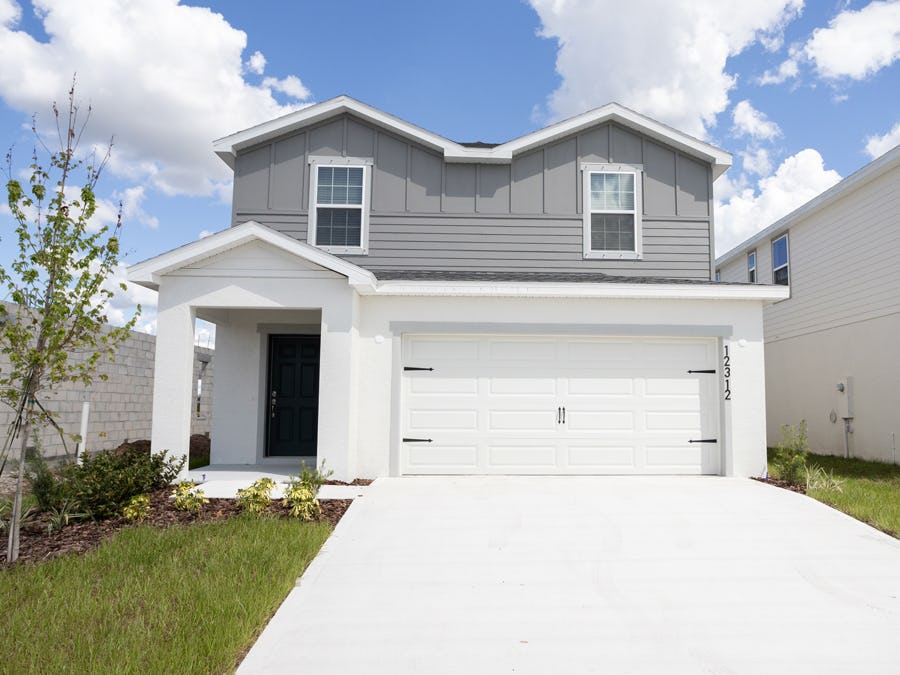 The accent color adds visual appeal to this two-story new construction home in Florida