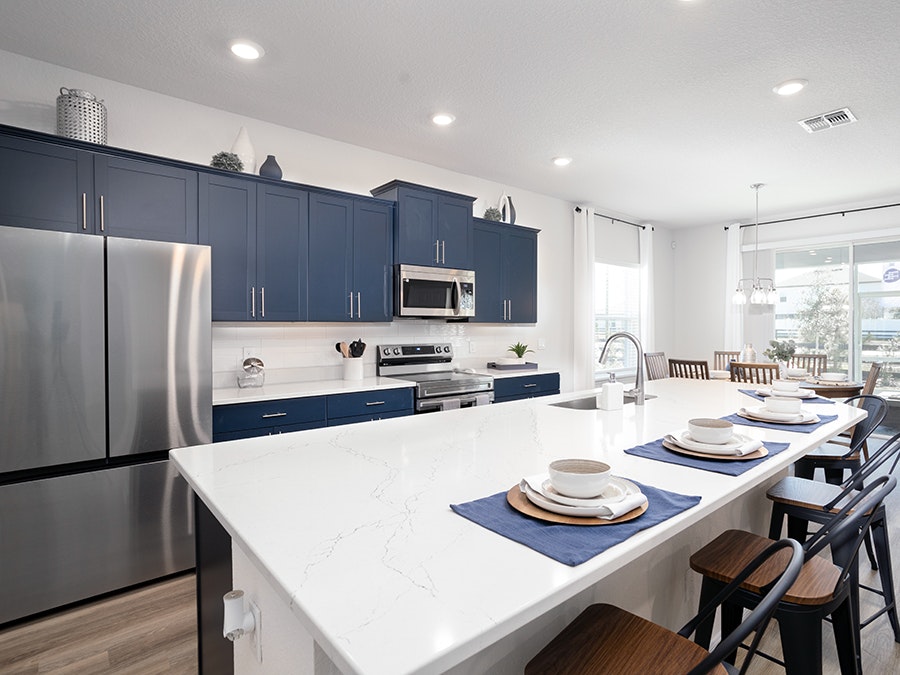 Trendy blue cabinets add a pop of color in the kitchen