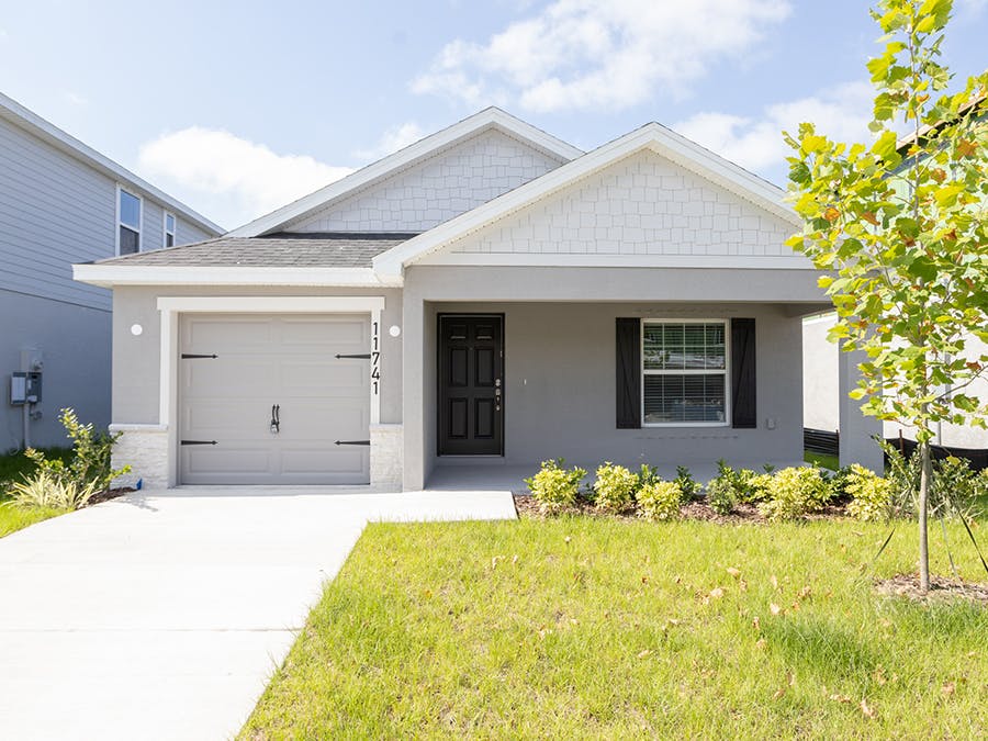 A Florida new home with Craftsman-style exterior details, a porch, and 1-car garage