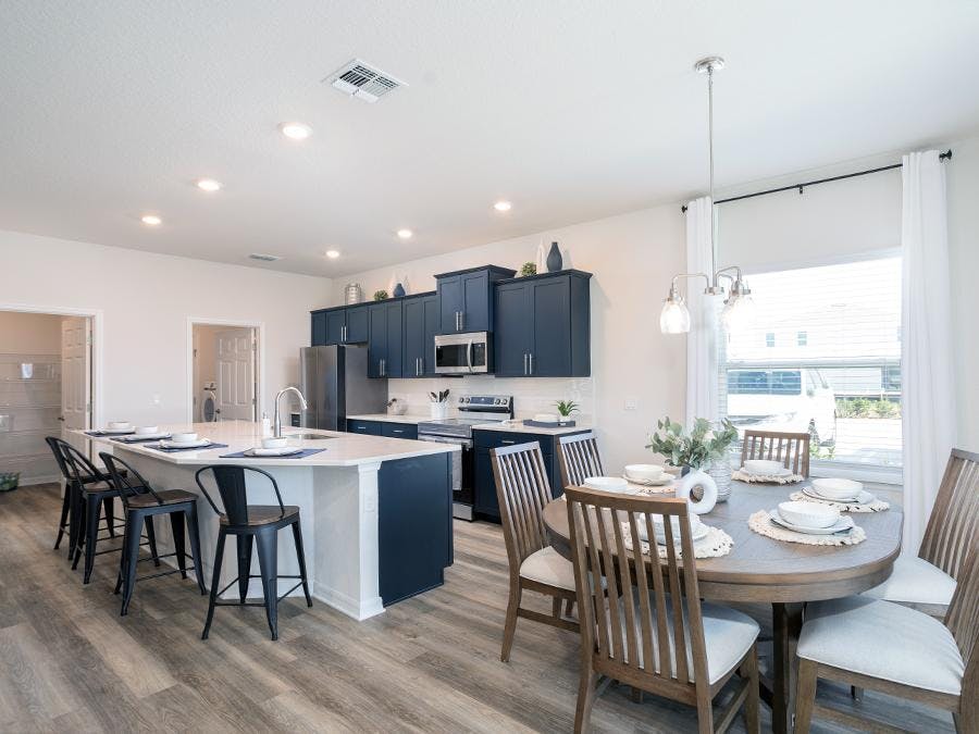 Kitchen with blue cabinets and quartz counters in a model home in St. Cloud, FL